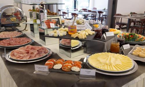 a buffet of different types of food on a counter at Best Western Hotel Turismo in San Martino Buon Albergo