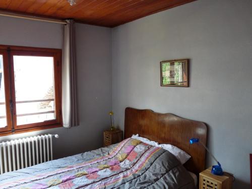 a bedroom with a bed and a window at Chalet Le Bois Noir in Valdeblore