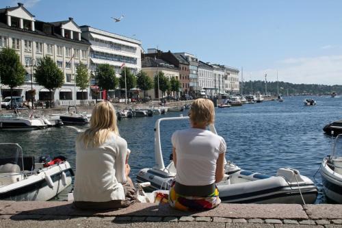 two people sitting on a boat in the water at Vesterveien Panorama in Arendal
