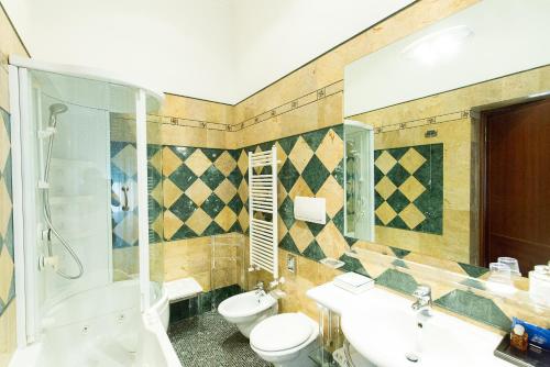 a bathroom with a toilet and a sink and a shower at Hotel Celio in Rome