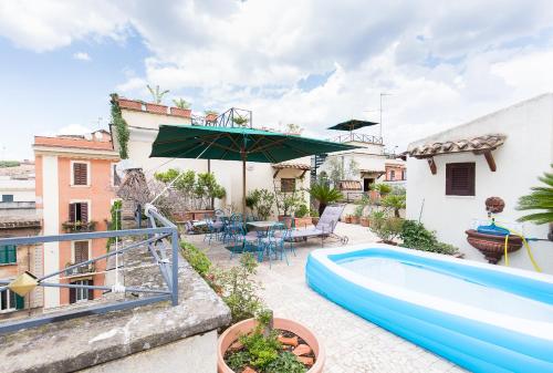 a backyard with a swimming pool and an umbrella at Hotel Celio in Rome