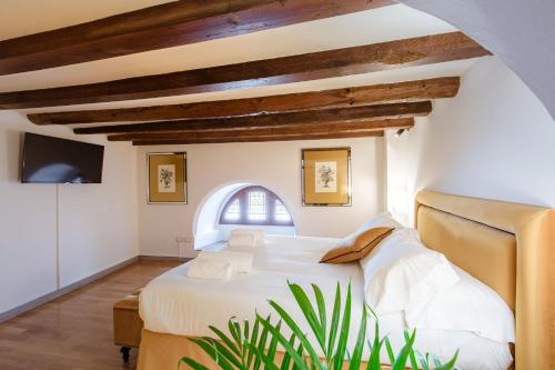 Ένα ή περισσότερα κρεβάτια σε δωμάτιο στο Relais Tosinghi
