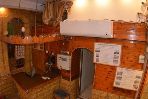 a room with a kitchen with a counter and a microwave at Palm Hostel in Jerusalem