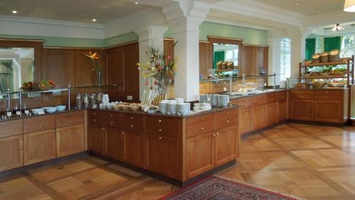 a large kitchen with wooden cabinets and a large island at Hollwegers Landhaus - Das Lisl in Sankt Gilgen