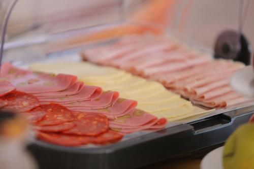 a bunch of different types of meats and cheese at Hotel Residencial Dora in Braga