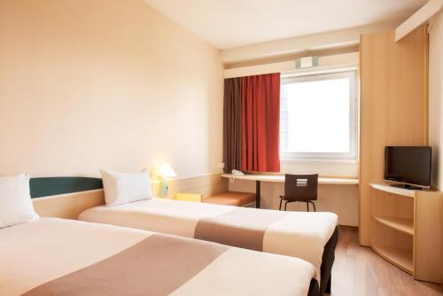 Кровать или кровати в номере Hotel Ibis Łódź Centrum