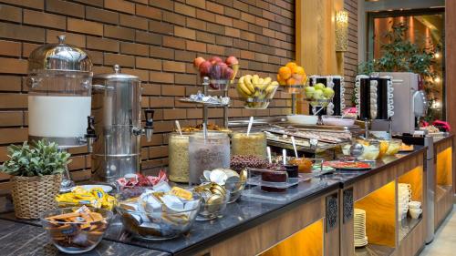 a buffet of food on a counter in a restaurant at Marmara Hotel Budapest in Budapest
