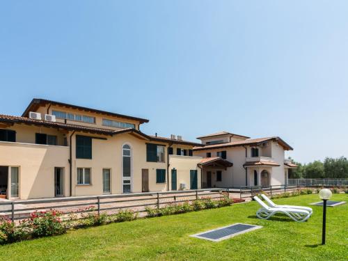 a lawn chair in front of a house at Agriturismo with pool next 9 hole golf course and close to Sal and more in Salò