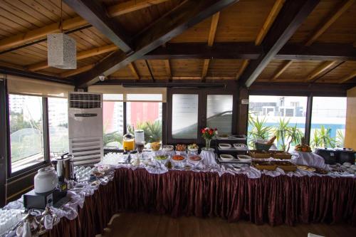 a table with food on it in a room with windows at Zahrat Al Jabal in Fès