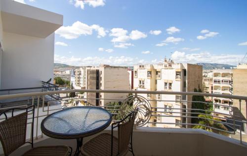 a balcony with chairs and a table on a balcony at Zahrat Al Jabal in Fès