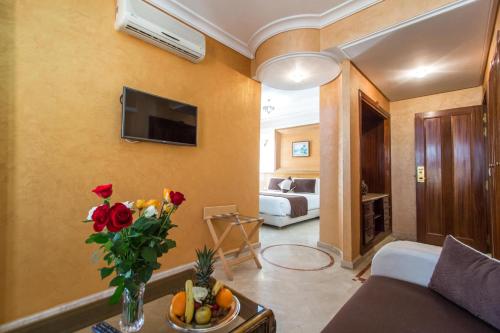 a living room with a couch and a table with flowers at Zahrat Al Jabal in Fès