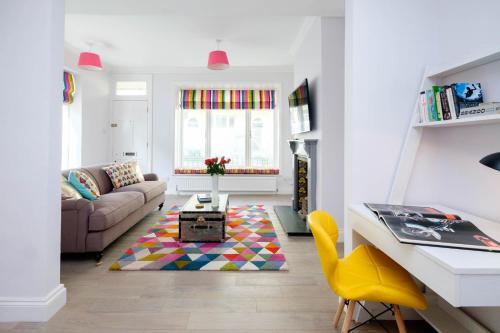 a living room with a couch and a table at Central Regency Town House in Brighton & Hove