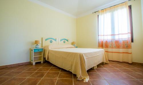 מיטה או מיטות בחדר ב-Appartamenti Sole di Sardegna