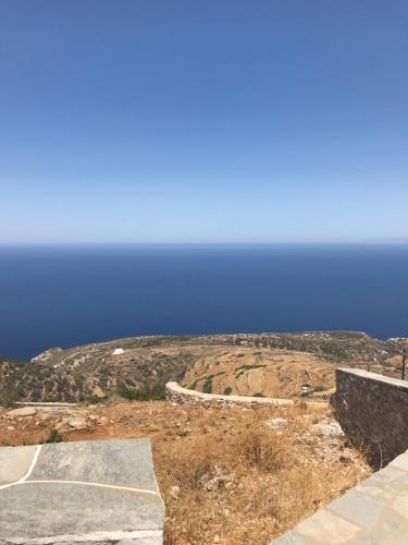 a parking lot with the ocean in the background at Windmill Villas in Artemonas