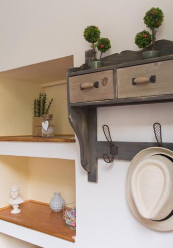 a bathroom with a shelf with a toilet and plants at Acro&Polis in Athens