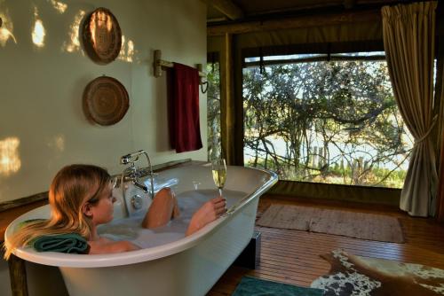 a little girl sitting in a bath tub at Sibuya Game Reserve and Lodge in Kenton on Sea