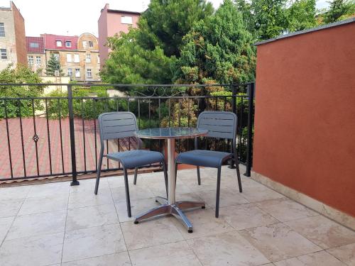 a table and two chairs sitting on a patio at Marcus in Bydgoszcz