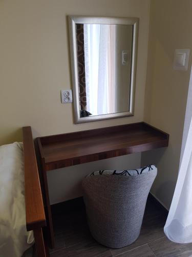 a mirror on a wall with a basket under it at Marcus in Bydgoszcz