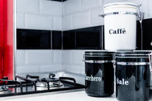 two cups sitting on top of a stove at Geco's Apartment in Elmas