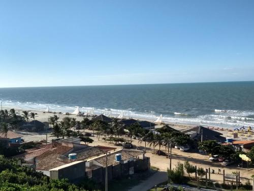 a view of a beach with palm trees and the ocean at Pousada Familiar Beberibe in Beberibe