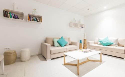 a living room with two couches and a coffee table at BLUESEA Gran Playa in Sa Coma