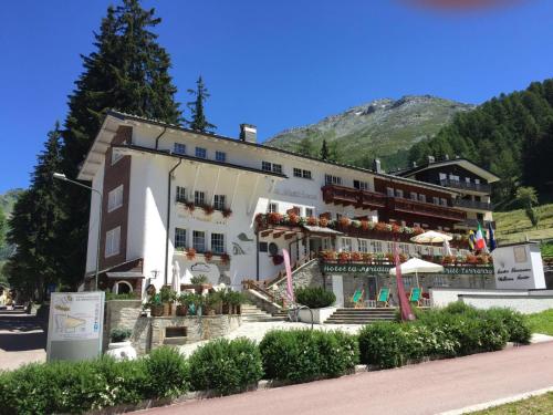 a large white building with flowers in front of it at Hotel La Meridiana in Madesimo