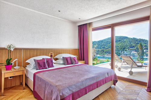 1 dormitorio con cama y ventana grande en Villa Malo More en Dubrovnik