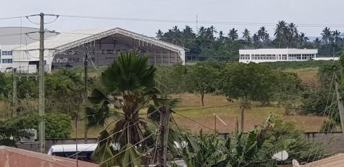 a building with a palm tree in front at B10 Airport Lodge in Dar es Salaam