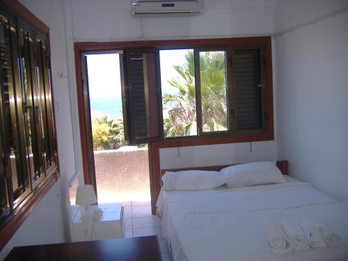 A bed or beds in a room at Theresa Hotel at Karpaz Peninsula