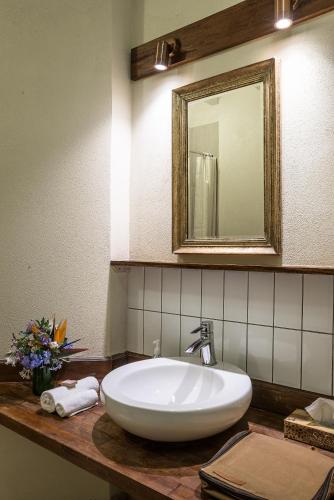 a bathroom with a white sink and a mirror at Karen Gables in Nairobi