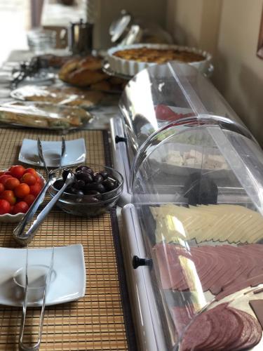 a buffet with cheese and fruit on a table at So Nice Hotel in Marathokampos
