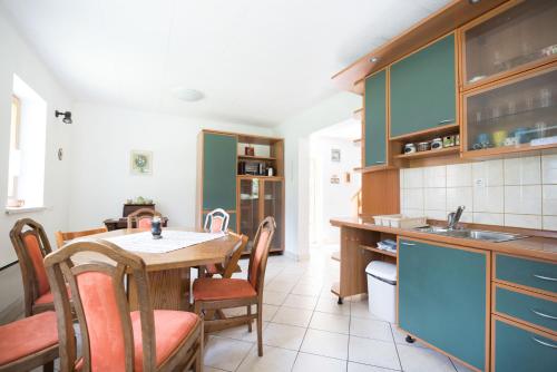 a kitchen with a table and chairs and a sink at Yellow house in Trenta