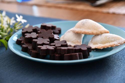 a blue plate with chocolate and cookies on a table at Casa Vacanze Il RossAntico in Modica