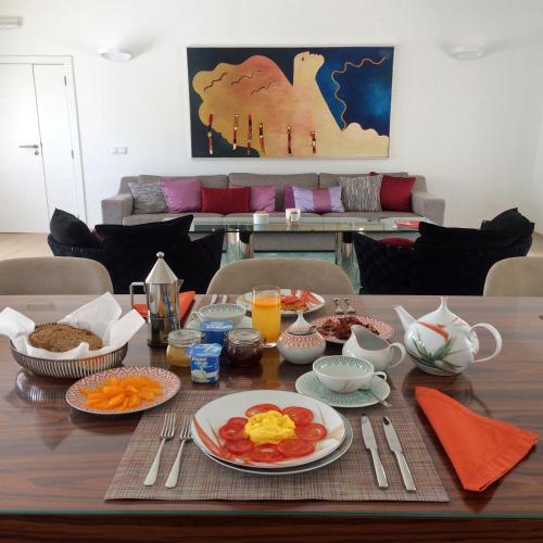 a dining room table with breakfast food on it at L&F House in Algoz
