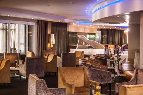 a restaurant with a bunch of chairs and tables at Coastlands Musgrave Hotel in Durban