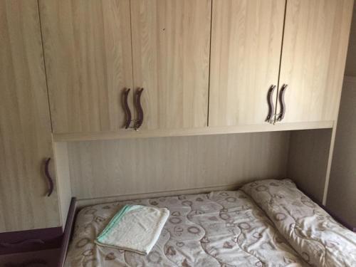 a bed in a room with wooden cabinets at Rudy Arenaile in Arenella
