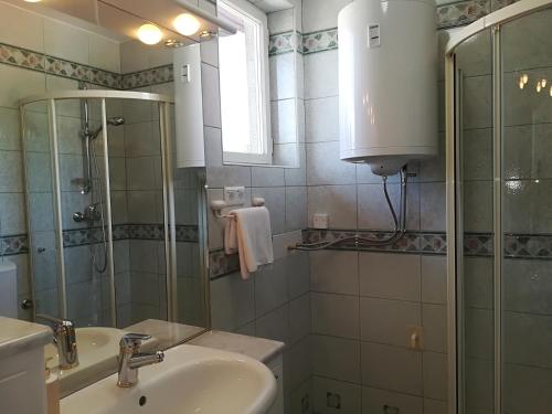 a bathroom with a sink and a shower at MB apartment Bled in Bled