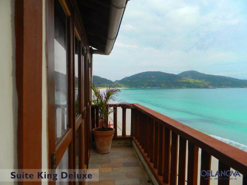 a balcony with a view of the water at Orlanova Hotel in Arraial do Cabo