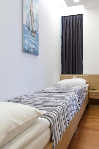 a bedroom with a bed with a picture on the wall at Dream Hotel in Velika Gorica