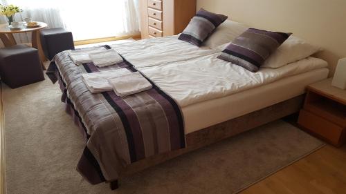 a bed with a blanket on it in a bedroom at Dom Gościnny Korab in Kołobrzeg