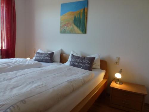 a bedroom with a bed with two pillows on it at Ferienwohnung Sauerlandblick in Korbach