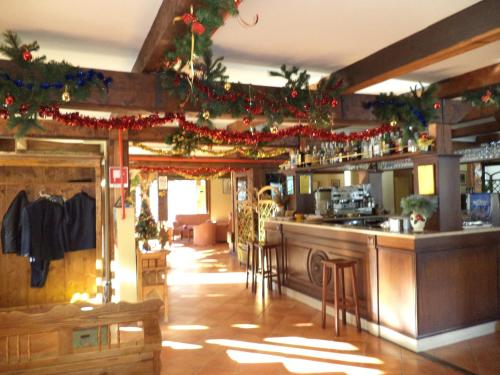 a bar in a restaurant with christmas decorations at Hotel Cà Fiore in Bardonecchia