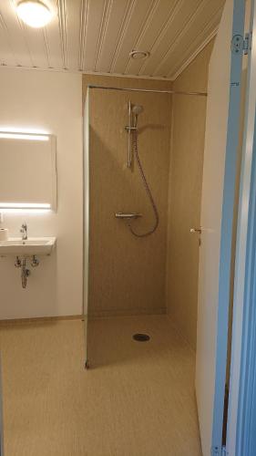 a bathroom with a shower and a sink at Aagaarden in Billund