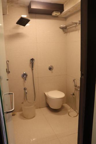 a bathroom with a toilet and a shower at Hotel Milan International in Mumbai