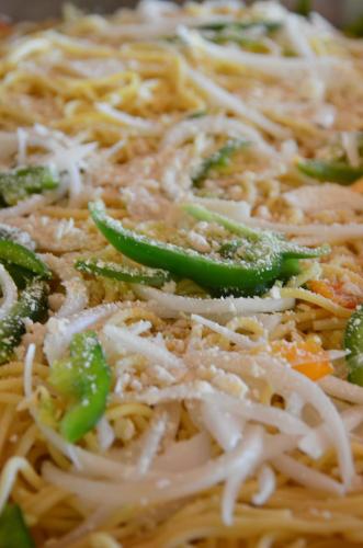 a close up of pasta with green peppers and cheese at Hotel Chichen Itza in Chichén-Itzá