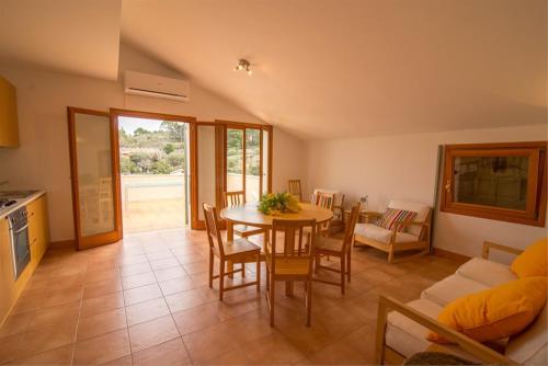 a kitchen and dining room with a table and chairs at Buganvilija C6 in Veli Lošinj