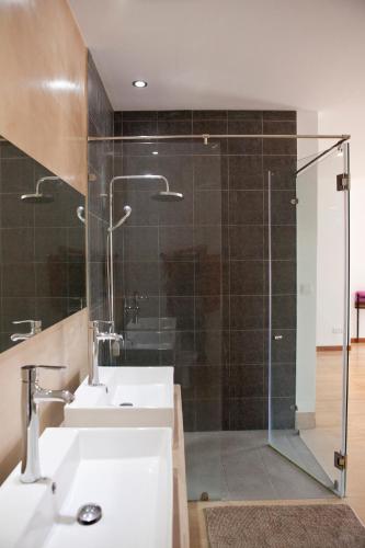 a bathroom with two sinks and a glass shower at Angkor Private villa Siem Reap in Siem Reap