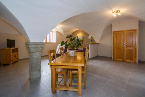 a dining room with a table and chairs in a room at Chambres d'hotes Les Clarines in Saint-Jacques-en-Valgodemard