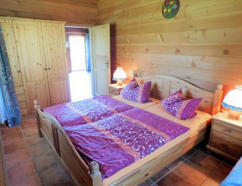 a bedroom with a bed in a log cabin at Blockhaus-Ferienpark in Eisenschmitt