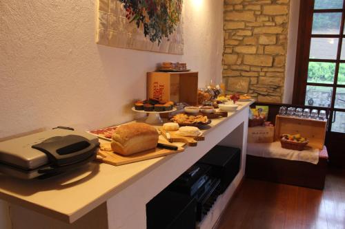 a table with food on a counter in a room at Agriturismo La Verena in Vesime
